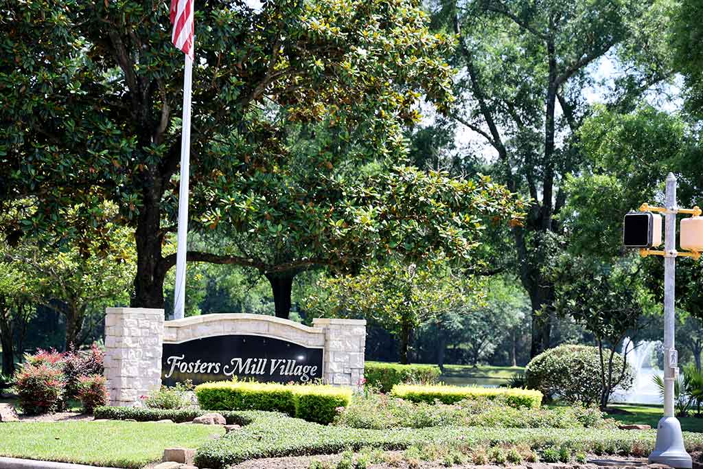 Entrance sign beside the pond in Fosters Mill Village, Kingwood, Texas