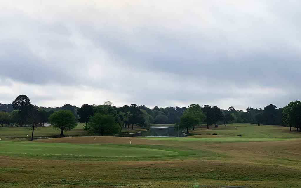 Putting green and pond at the Oakhurst golf course in Kingwood, Texas
